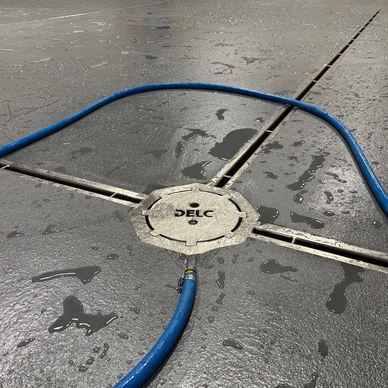 Round stainless steel area drain set flush into fresh concrete