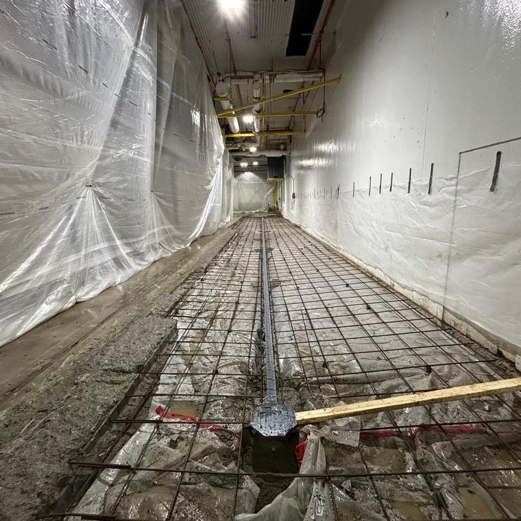 Drain trench formed and tied in with rebar inside a room under construction