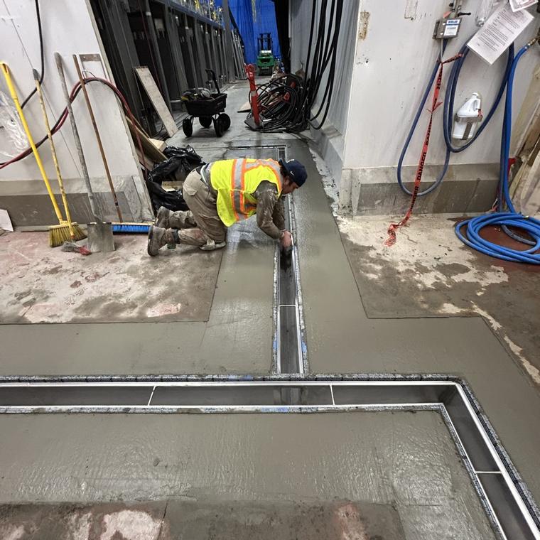 Installer tying a stainless drain run into its outlet connection on site