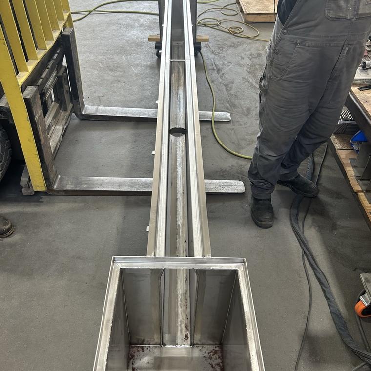 Stainless steel slot drain body and sump box being fabricated in the shop